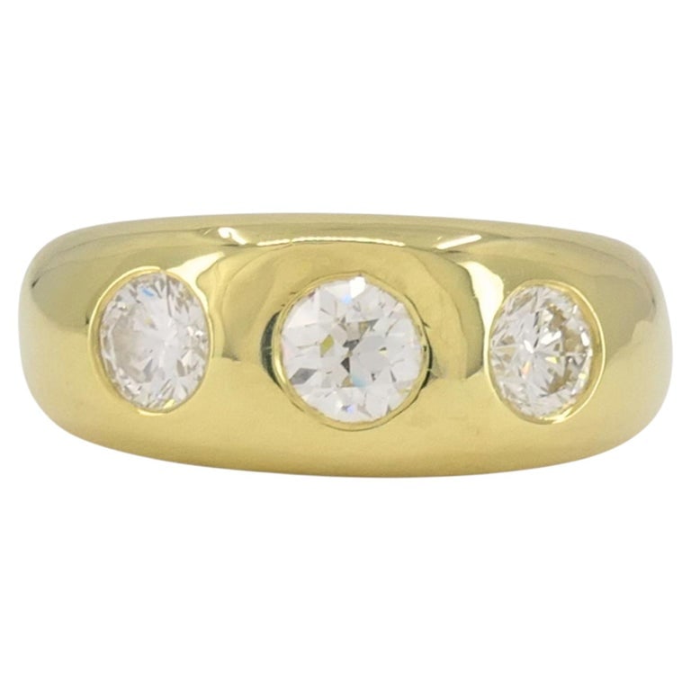 Vintage 18k Yellow Gold Three Stone Diamond Gypsy Ring: This vintage 18k yellow gold three stone diamond ring reflects the traditional gypsy ring style, known for its solid construction and flush set stones. Crafted in a smooth, rounded form, the band