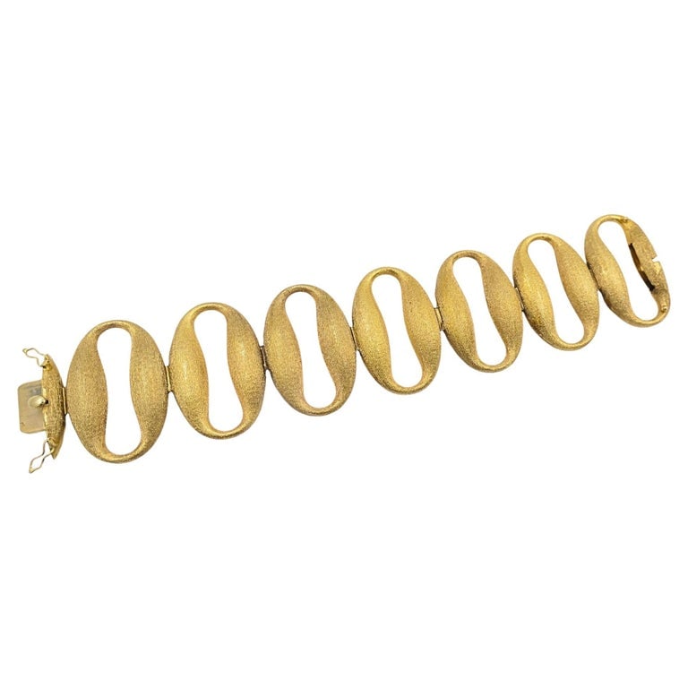 Vintage 14k Gold Modernist Open Oval Link Bracelet: This vintage 14k gold bracelet is a striking example of midâ€‘century modernist design, crafted in a series of oversized open oval links with a brushed texture contrasted by
