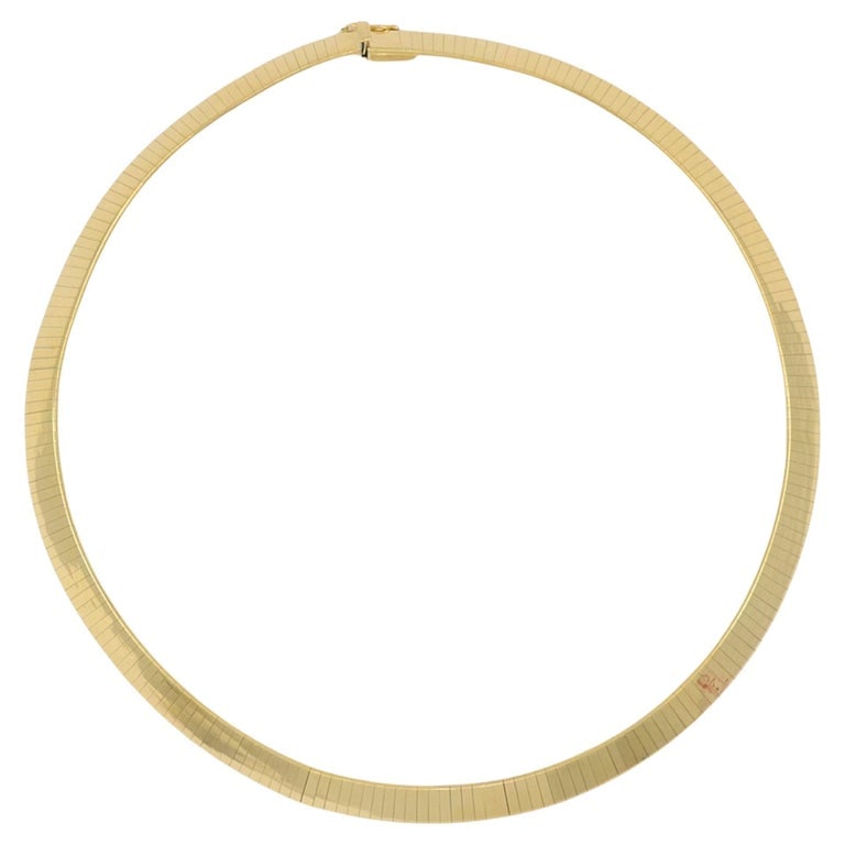 Italian Collar Necklace 14k Gold Estate Jewelry: An Italian gold necklace features a sleek collar necklace style made from 14k yellow gold. The necklace sits close to the neckline and forms a smooth, structured circle when worn. The piece is