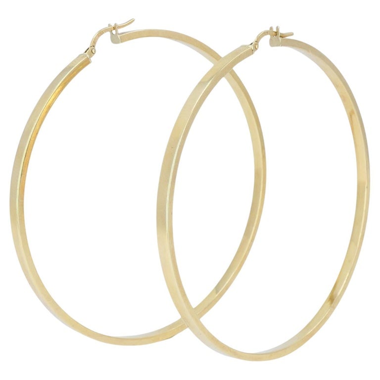 Vintage Italian 14k Gold Hoop Earrings, Late 20th Century: These Italian 14k gold hoop earrings feature a classic large hoop design crafted with a smooth tubular profile. The hoops are formed in a continuous circular shape with a polished surface that