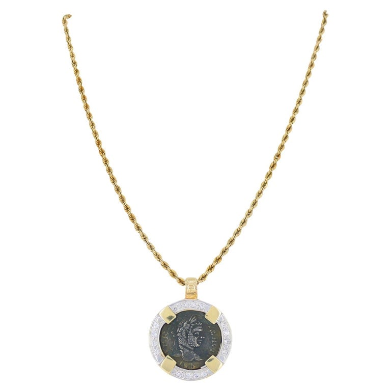 Vintage 14k Gold Diamond Ancient Coin Pendant Necklace: This vintage coin pendant necklace centers on an authentic ancient Roman bronze coin dating to the Imperial Roman era, circa 1stâ€“3rd century AD, preserved in its original aged