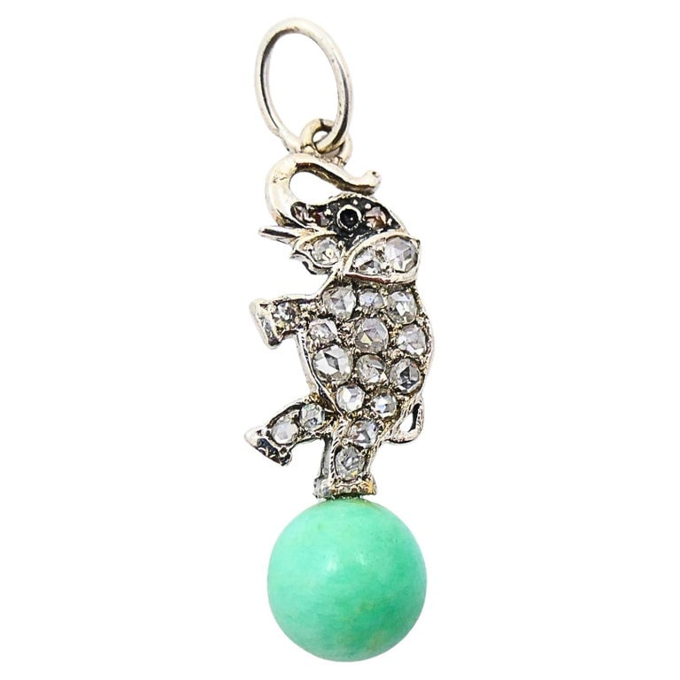 Antique Elephant Charm 14k White Gold Diamond Bead Accent: An antique elephant charm made of 14k white gold, diamonds and a green gemstone bead. The elephantâ€™s body is covered in shimmering stones, forming a bright diamond charm. Suspended