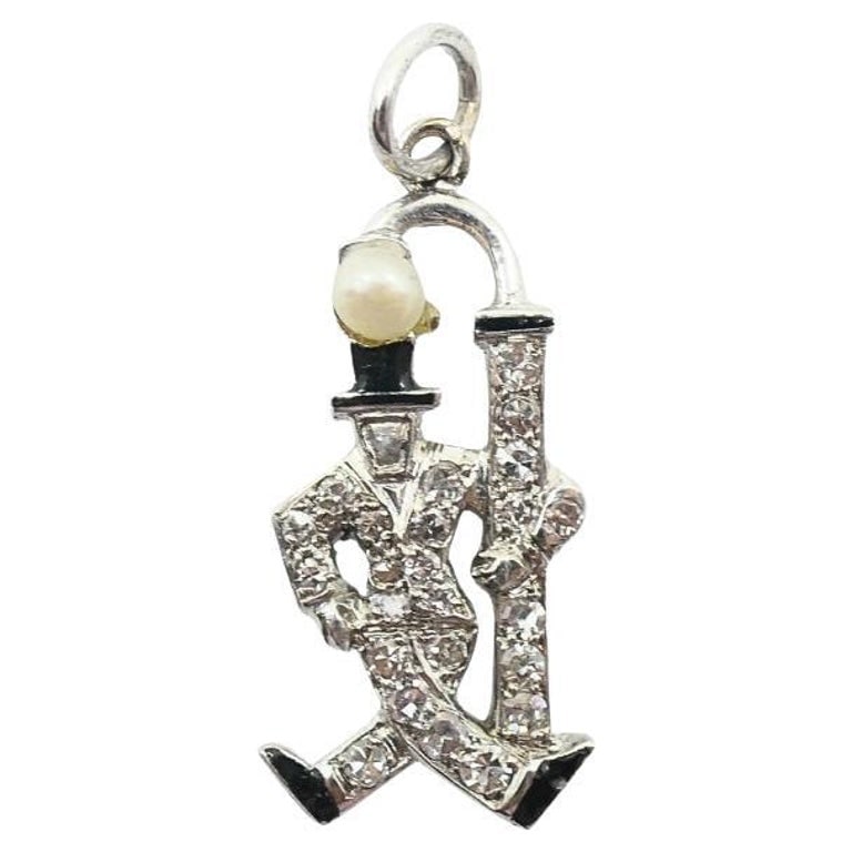 Platinum Diamond Walking Gentleman Charm Pearl Head: Platinum diamond charm depicting a walking gentleman with cane, measuring approximately 1/4 inch by 3/4 inch and weighing 2 grams, ideal for a fine charm bracelet or necklace. Crafted in platinum and 