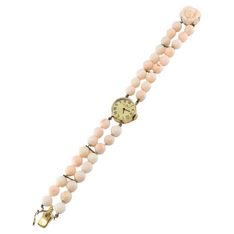 Baume & Mercier 14k Angel Skin Coral Double Strand Bracelet Watch, 1960s: Product details: A feminine vintage Baume & Mercier bracelet watch crafted in 14k gold and set with angelâ€‘skin coral beads. The doubleâ€‘strand design