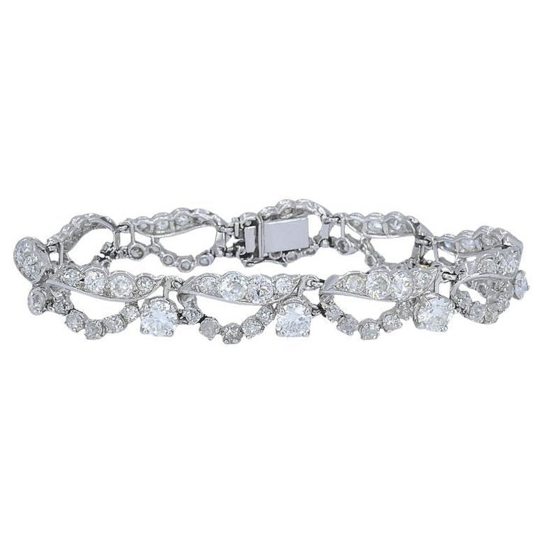 French Platinum Diamond Openwork Diamond Bracelet, 1960s: This French platinum diamond bracelet showcases a refined openwork design that balances vintage craftsmanship with clean geometry. Measuring 3/8 inch wide and 6 1/2 inches long, with a total weight