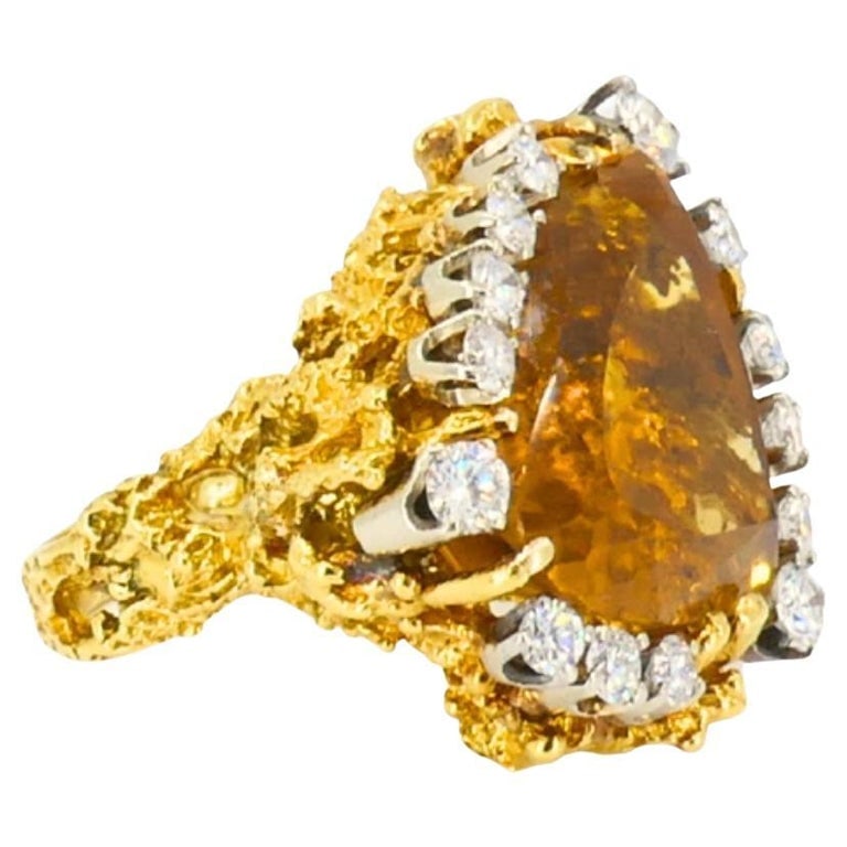 Vintage 18k Gold Citrine Diamond Ring Brutalist Design: This vintage 18k gold ring features a bold brutalist design with an organic, textured structure. At the center sits an oval citrine, showing warm golden-amber tones. The gemstone is framed by a row