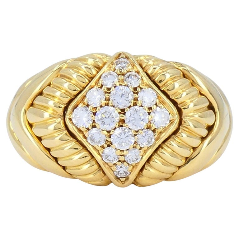 Vintage Boucheron 18k Gold Diamond Dome Ring: This Boucheron ring, crafted in 18k yellow gold, dates to the late 1980s to early 1990s. The design features sculpted fluted shoulders that frame a raised diamond panel set in a geometric lozenge