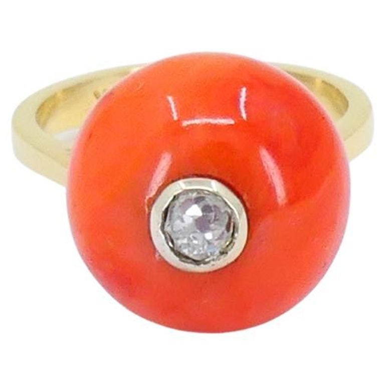 Vintage 14k Gold Coral Ring Diamond Accent: A vintage 14k gold coral ring with a diamond accent. At its center sits a vivid coral bead, polished to a smooth finish. The coralâ€™s orange hue contrasts elegantly with the cool