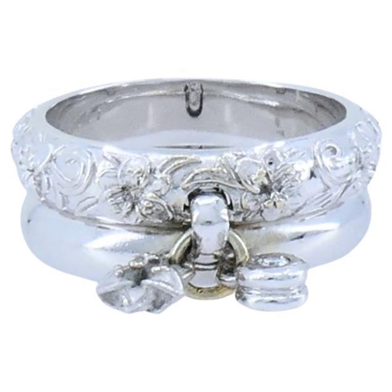 Carrera y Carrera 18k White Gold Double Ring Diamond Floral Design: This vintage Carrera y Carrera ring is crafted in 18k white gold and features a distinctive double band design. One band is smooth and polished, while the other has a detailed floral motif with carved