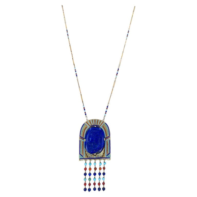 Egyptian Revival 14k Gold Gemstones Enamel Pendant Necklace: A magnificent example of Art Deco Egyptian Revival design, this early 20th century necklace captures the allure of ancient symbolism through impeccable craftsmanship and bold color. The centerpiece