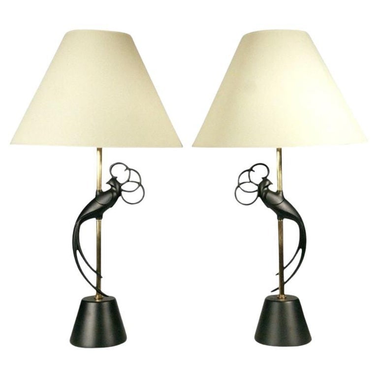 Mid-century Brass & Steel "Lovebird" Sculptral Table Lamp by Rembrandt , Pair: This pair of mid-century modern table lamps by the Rembrandt Company features a sinuous lovebirds rendered in black enameled steel and attached to the brass stem. The lamps retain their original glass