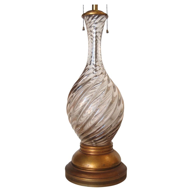 Italian Mid-century Pink Swirled Murano Glass Table Lamp w/ Brass Base: Italian Pink Metalic Swirled Murano Glass Table Lamp On Gold Wood Base With Double Pull Chain Holds Two Bulbs. Measures 7" Diameter x 35" Tall Italy, 1960 Reserve: $1,350.00 Shipping: Domestic: Shippi