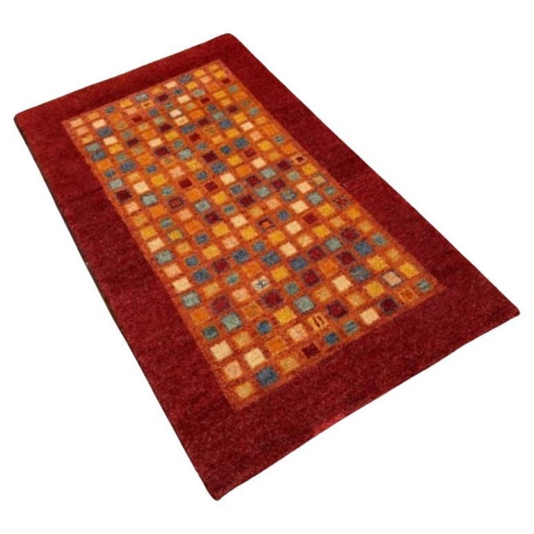 Mid Century Gabbeh Inspired Wool Area Rug: Enhance your space with this wool abstract Mid-century area rug. Featuring a captivating blend of geometric shapes and vibrant hues, this rug fashions after the rugs made famous by the Gabbeh Tribe.