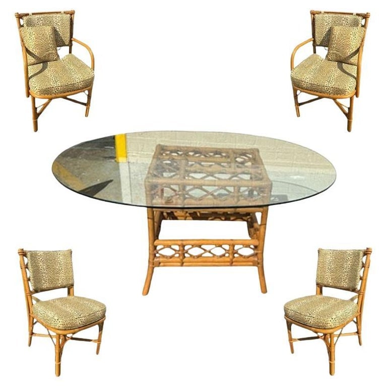 Restored Mid-century Rattan Dining Table & Chairs w/ Leopard Print Cushions: Elevate your dining experience with his beautifully restored, exquisite dining table set featuring a single-strand rattan glass-top dining table paired with charming set of 4 chairs adorned with styli