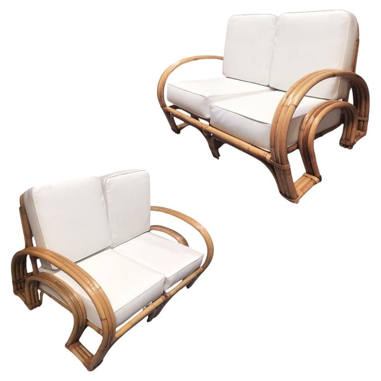 Restored Mid-century Rattan Double Horseshoe Settee Sofa, Pair: This beautifully restored mid-century rattan Double Horseshoe arm settee showcases timeless charm with its vintage appeal. Crafted with solid construction and three-strand arms, it exudes both