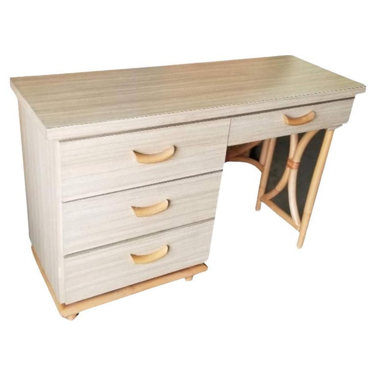Restored Rattan and Formica Desk with Drawers and Hourglass Rattan Sides: This beautifully restored Paul Frankl-inspired mid-century desk showcases blonde Formica with drawers, enclosed in an hourglass-shaped rattan frame. It's unique design flaunts curved rattan drawer pul