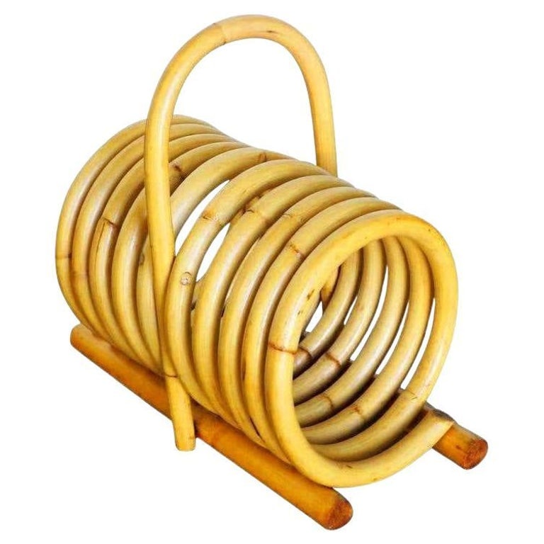 Restored Rattan Magazine Holder with Carrying Handle: Rattan magazine holder with carrying handle. This Rattan magazine holder features a single-coil steam bent rattan spring for holding up to nine magazines and easy to carry handle. Designed in the
