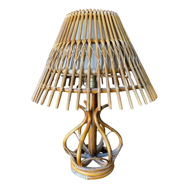 Restored Modernist Stacked Stick Reed Rattan Table Lamp w/ Rattan Shade: This beautifully restored Paul Frankl-inspired modernist stacked stick rattan table lamp with outward stick rattan fan shade. Lamp: 20" tall x 12.5" wide x 6" deep Shade: 10" X 15" We only purchase