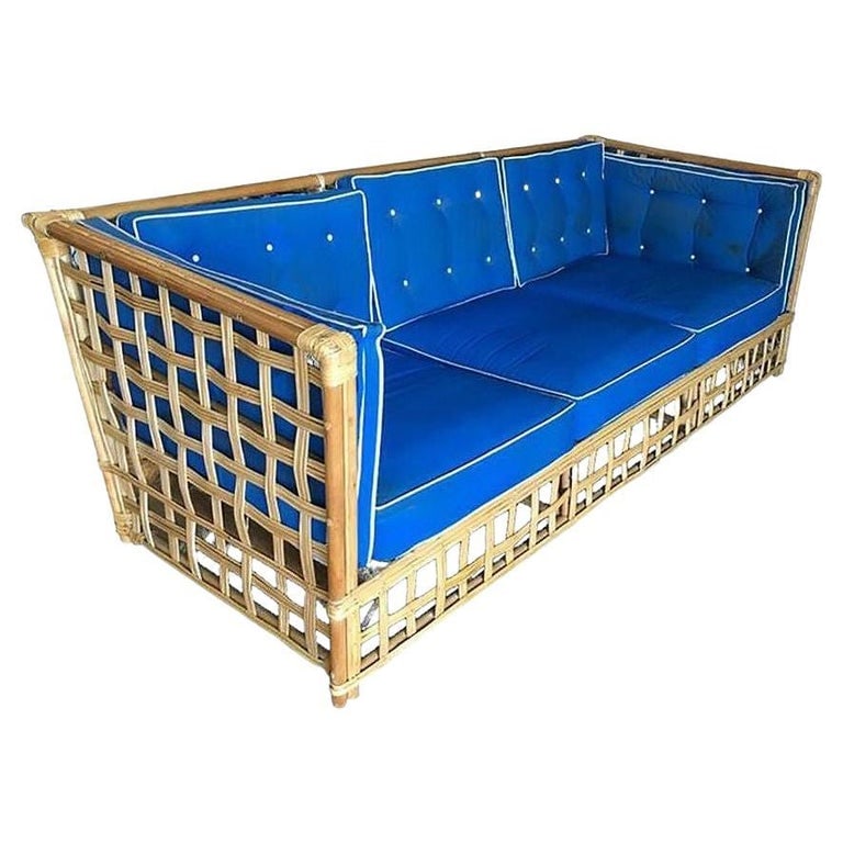 Restored Milo Baughman Style Stick Reed Rattan Cubists Sofa: Mid-Century Baughman style rattan sofa with woven stick rattan sides and pole rattan frame. The seats are covered in tuft blue cloth cushions. 1950, United States Sofa: 34" tall X 81" wide X 36" deep,