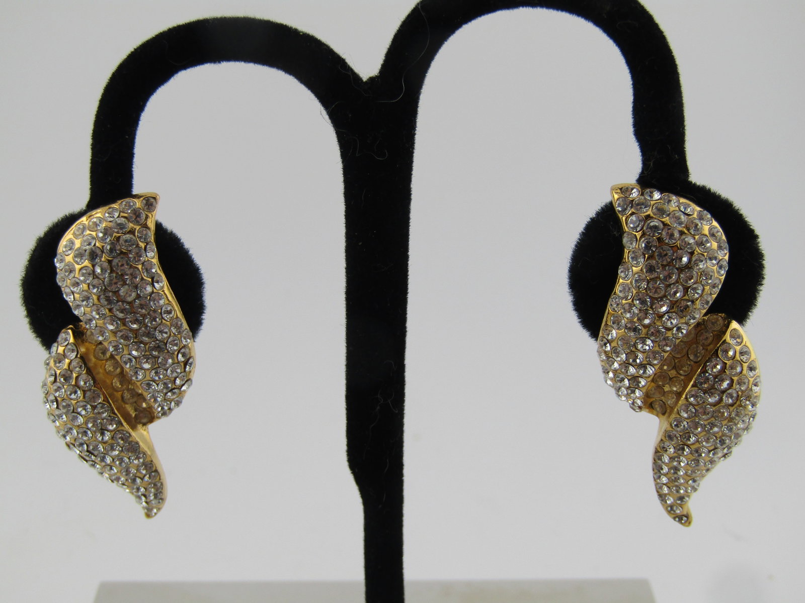 Vintage Pave Rhinestone Clip Earrings, Signed Jarin, 1990's: Title: Vintage Pave Rhinestone Clip Earrings, Signed Jarin, 1990's Description: Vintage Pave Rhinestone Clip Earrings, Signed Jarin, 1990's. Yellow gold tone with two curved raised squiggles and a rec