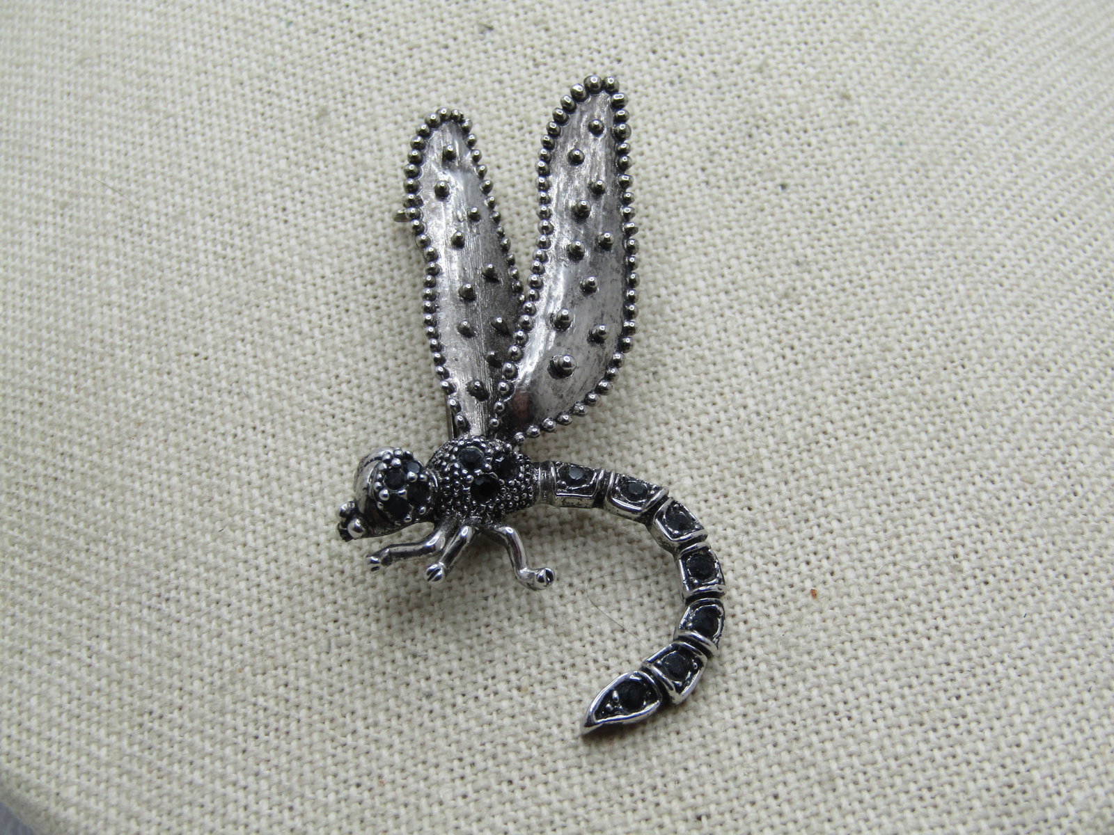 Vintage Dragonfly Brooch, Black Glass Stones, 1980's: Title: Vintage Dragonfly Brooch, Black Glass Stones, 1980's Description: Vintage Dragonfly Brooch, Black Glass Stones, 1980's. It has a textured finish with a darker washed look to it. The bod is