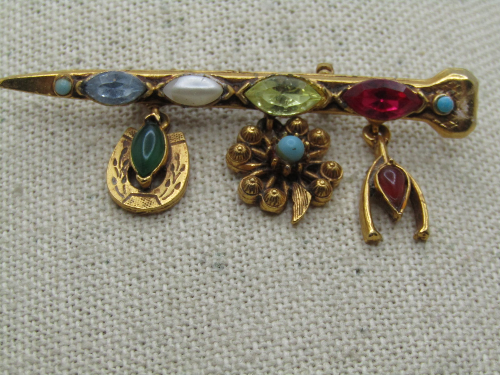 Vintage Florenza Dangling Bar Brooch, 1960's, Rhinestones: Title: Vintage Florenza Dangling Bar Brooch, 1960's, Rhinestones Description: Vintage Florenza Dangling Bar Brooch, 1960's, Rhinestones. This has a nail like bar brooch with a small faux snakeye turqu