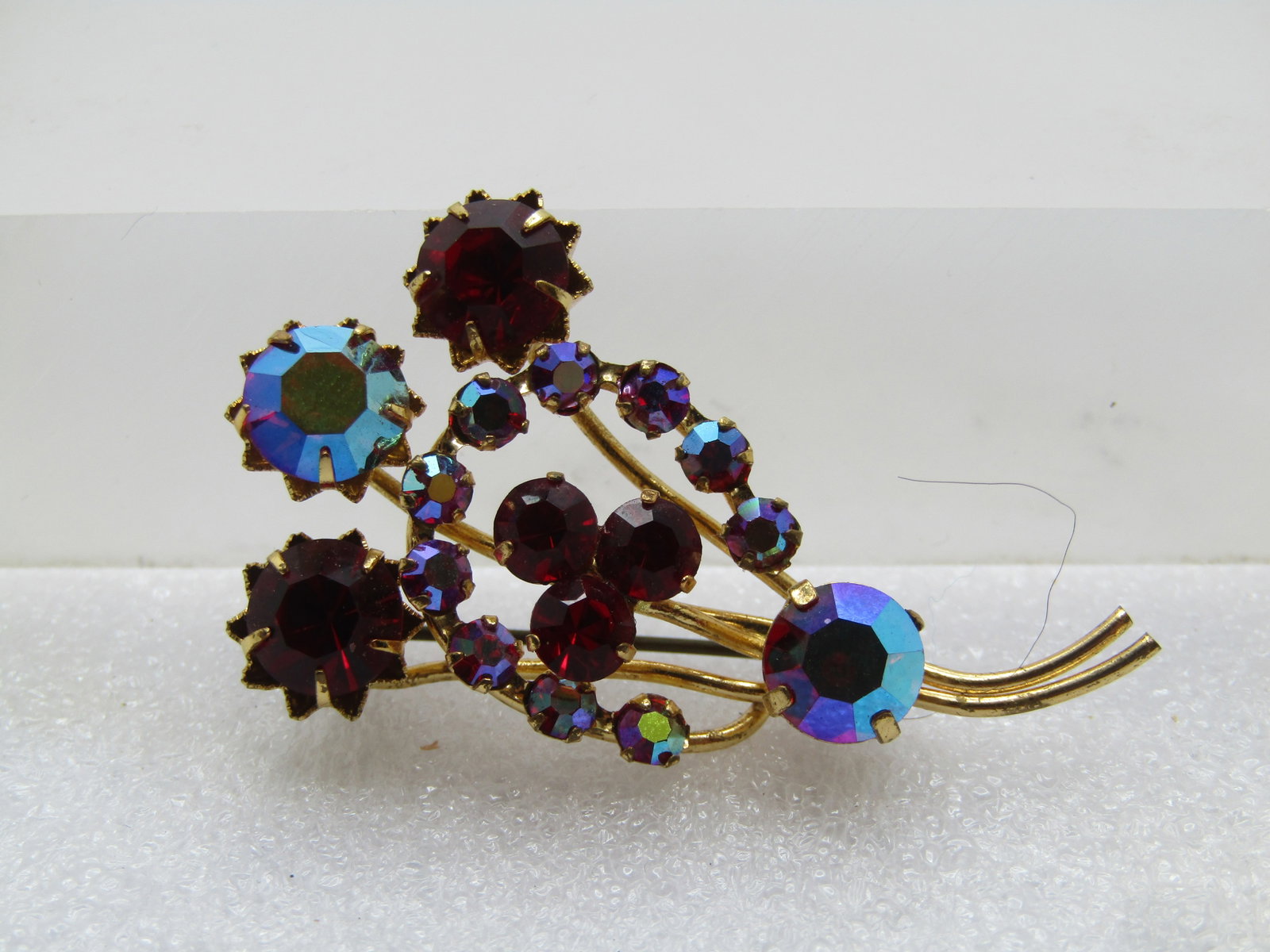 Vintage Red and AB Rhinestone Stem Brooch, 1960's: Title: Vintage Red and AB Rhinestone Stem Brooch, 1960's Description: Vintage Red and AB Rhinestone Stem Brooch, 1960's. Gold tone with larger round red and red aurora borealis rhinestone blossom