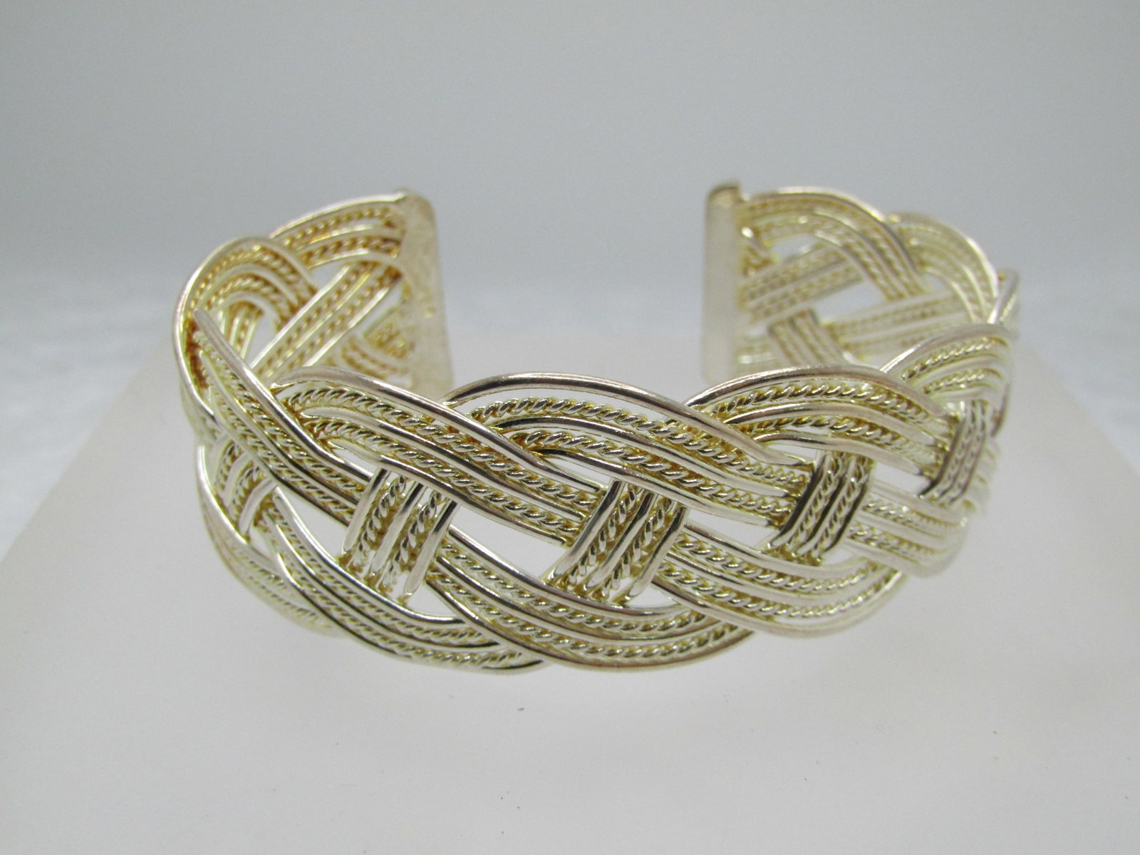 Silver Plated Woven Cuff Bracelet, Adjustable 6"-8", 1" Wide: Title: Silver Plated Woven Cuff Bracelet, Adjustable 6"-8", 1" Wide Description: Silver Plated Woven Cuff Bracelet, Adjustable 6"-8", 1" Wide. Four woven strands of smooth raised edges and recessed ro