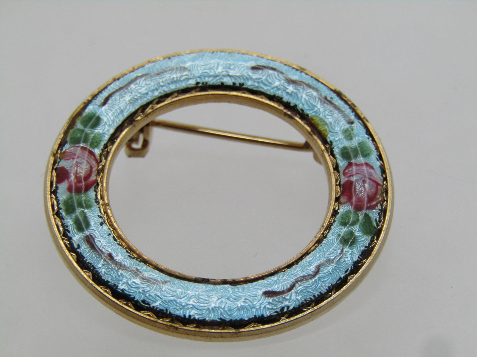 Vintage Floral Guilloche Circle Brooch, 1960's: Title: Vintage Floral Guilloche Circle Brooch, 1960's Description: Vintage Floral Guilloche Circle Brooch, 1960's. It is gold tone and appx. 1.25" across. Aqua blue with pink roses and brown vines.