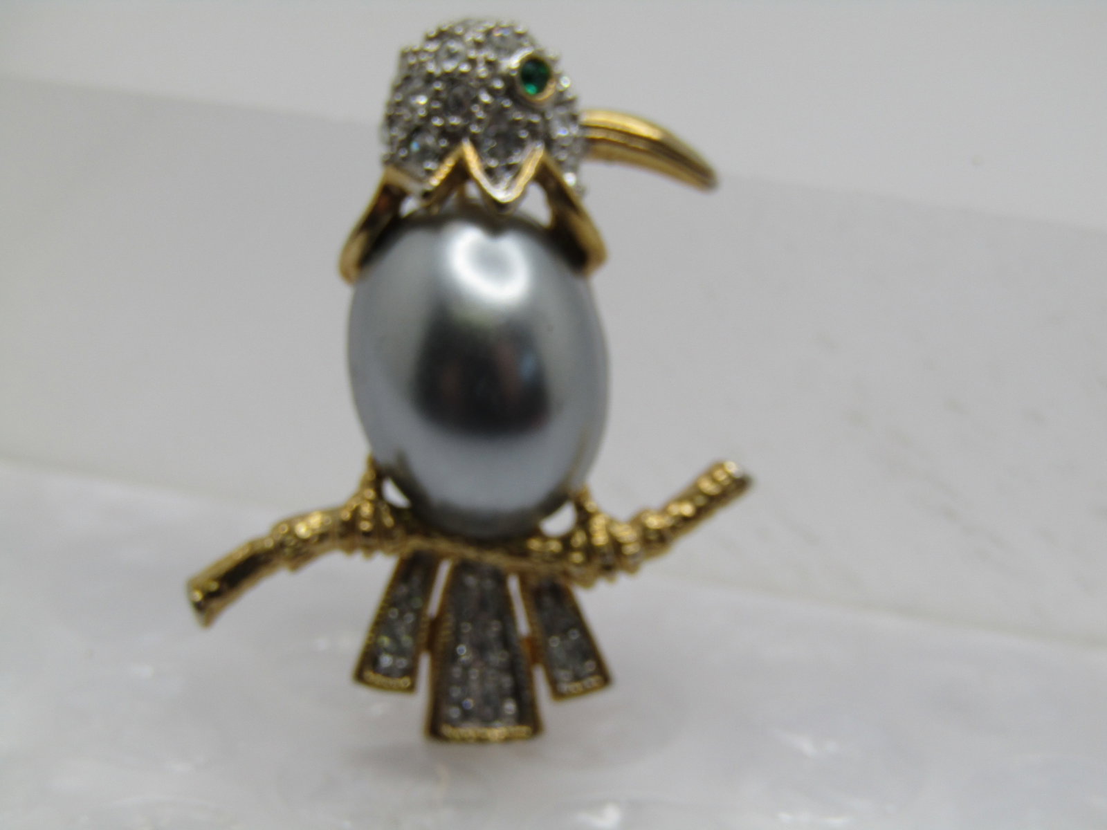 Vintage Faux Pearl and Rhinestone Bird Brooch, on Branch, 1980's: Title: Vintage Faux Pearl and Rhinestone Bird Brooch, on Branch, 1980's Description: Vintage Faux Pearl and Rhinestone Bird Brooch, on Branch, 1980's. SIlvery faux Tahitian pearl torst with pave set c