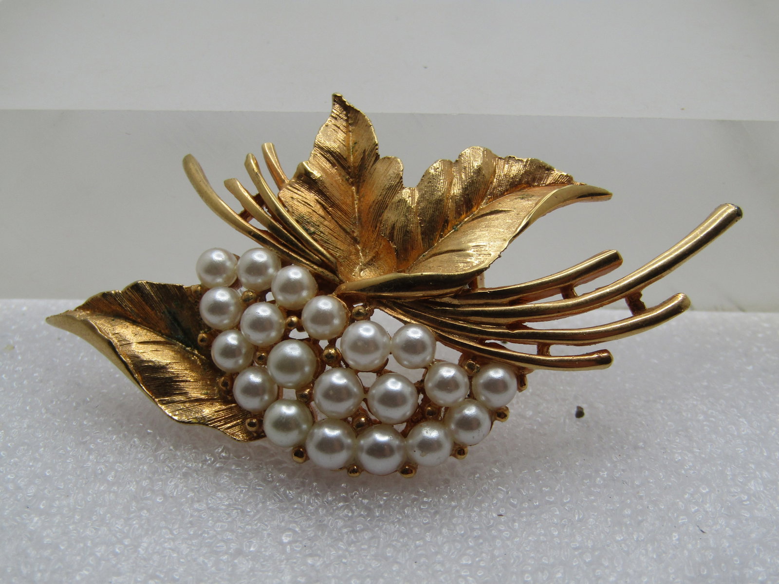 Vintage Faux Pearl Leaf Cluster Brooch, 1960's: Title: Vintage Faux Pearl Leaf Cluster Brooch, 1960's Description: Vintage Faux Pearl Leaf Cluster Brooch, 1960's/ Gold tone with textured and detailed shimmery leavews and four curved stem accents wi