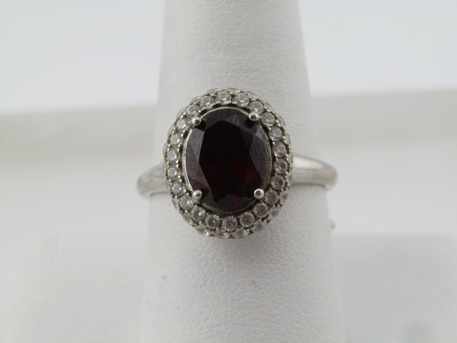 Sterling Silver Red Tourmaline CZ Ring, Sz. 9.5, 1990's, Signed: Title: Sterling Silver Red Tourmaline CZ Ring, Sz. 9.5, 1990's, Signed Description: Sterling Silver Red Tourmaline CZ Ring, Sz. 9.5, 1990's, Signed GSK. It is tiered with two concentric halos of