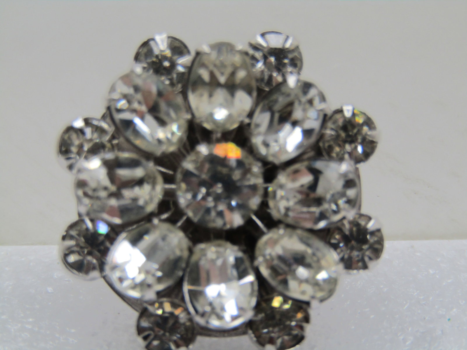 Vintage Sterling Tiered Rhinestone Brooch, Blossom, 1960's: Title: Vintage Sterling Tiered Rhinestone Brooch, Blossom, 1960's Description: Vintage Sterling Tiered Rhinestone Brooch, Blossom, 1960's. The brooch is appx. 1" across and has clear, 4.5mm round