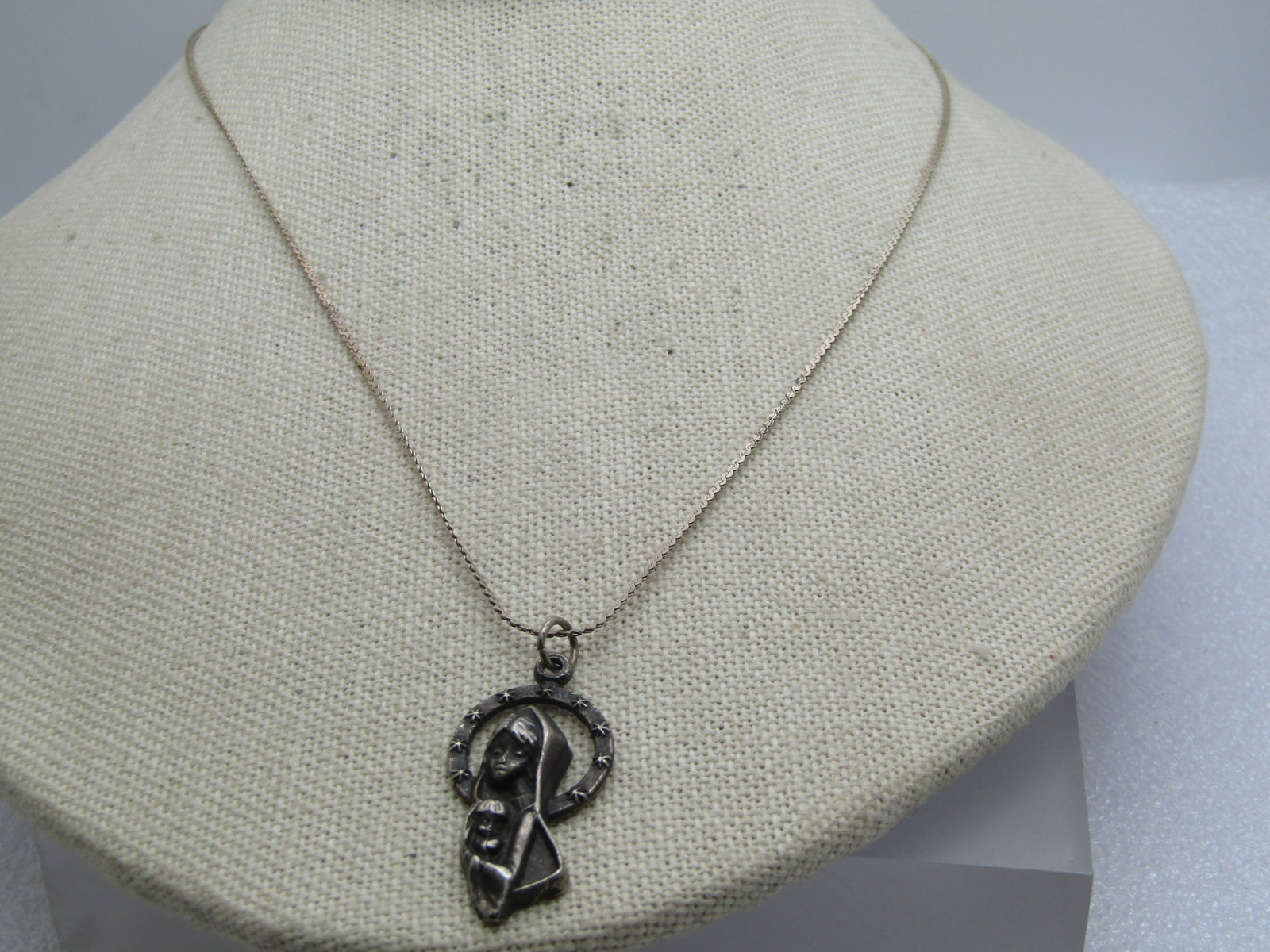 Vintage Sterling Necklace with Mother and Child Pendant, 16": Title: Vintage Sterling Necklace with Mother and Child Pendant, 16" Description: Vintage Sterling Necklace with Mother and Child Pendant, 16". 1mm wide herringbone sterling chain - the pendant is not 
