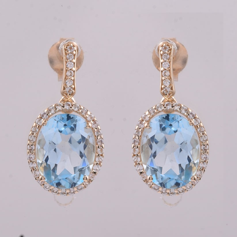 4.75 Ct Oval Blue Topaz 9K Gold Earrings: 4.75 Total Carat Blue Topaz 9K Gold Earringsm Specifications: Total Weight 2.511 g Center Gemstone Blue Topaz Gemstone Carat Weight 4.45 Carats Gemstone Measurements 9X7 mm Additional Gemstones White