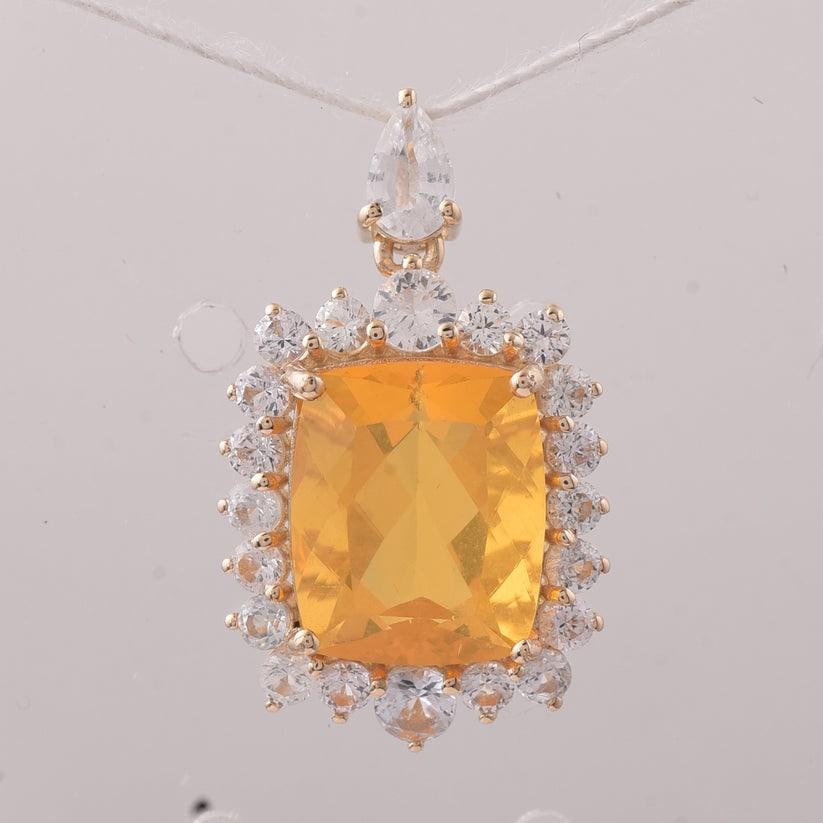 4.14 Ct Cushion Fire Opal 9K Gold Pendant: 4.14 Total Carat Fire Opal 9K Gold Pendant Specifications: Total Weight 1.866 g Center Gemstone Fire Opal Gemstone Carat Weight 2.84 Carats Gemstone Measurements 10.90X9X6.10 mm Additional Gemstones