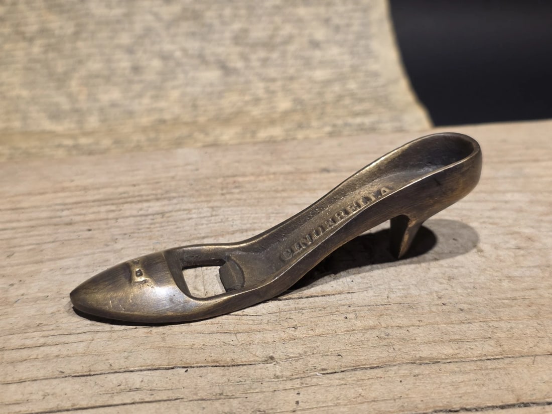 5" Brass "Cinderella" High Heel Shoe Bottle Opener: 5" Long Vintage Style Brass "Cinderella" High Heel Shoe Bottle Opener Step up your barware game with this charming and functional conversation piece. This reproduction bottle opener is crafted in the 