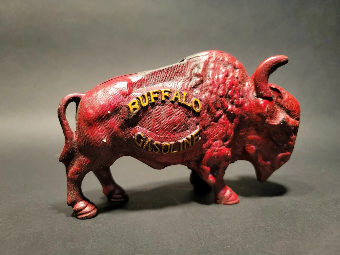 Buffalo Gasoline Cast Iron Coin Bank: 7 1/2" Long x 5" High Great reproduction cast iron Buffalo Gasoline coin bank. This piece was made to look just like an antique, but is actually new. Great aged red paint. Reserve: $40.00 Shipping: