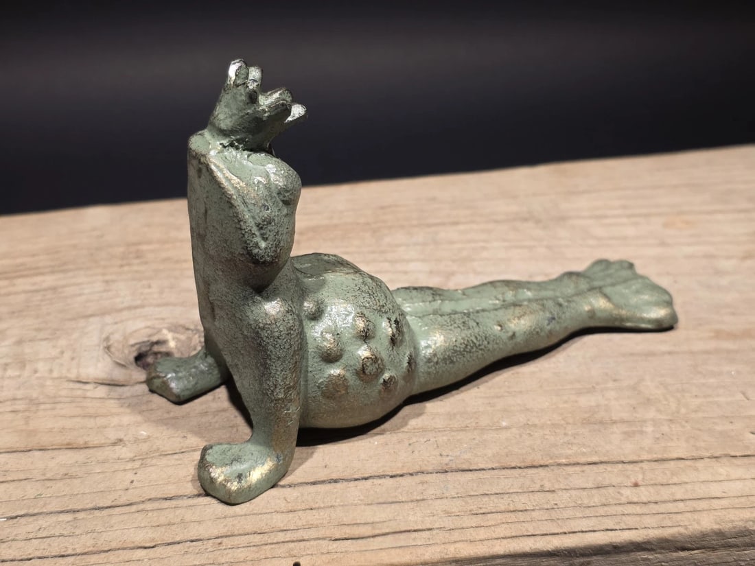 Cast Iron Yoga Frog Door Stop or Garden Statue: Nice reproduction cast iron door stopper. As you can see it is finished in a verdigris aged copper finish. Nice detail, particularly in the "spotted" texture of the back and the points of the crown.