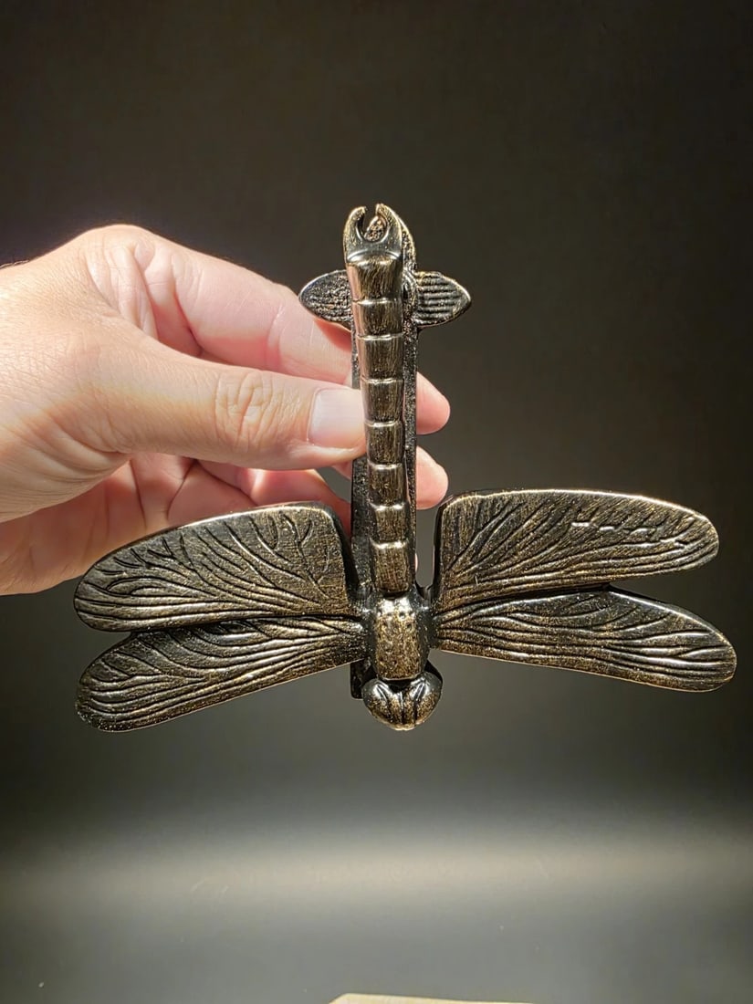 Antique Brass Cast Iron Dragonfly Door Knocker: 4 3/4" Tall x 6 1/4" wide A finely cast reproduction iron dragonfly door knocker with an aged bronze finish that captures the beauty of early 20th-century folk ironwork. The piece has a lightly