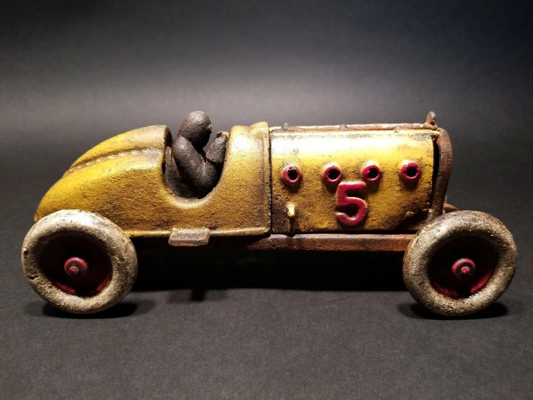 Cast Iron #5 Yellow Toy Race Car w Lifting Hood: 9" Long x 3 1/2" Wide 3 3/4" Tall 2 lbs 13 oz Such a neat reproduction cast iron car! As you can see this heavy cast iron car was wonderfully hand painted and distressed to look original. The car is m