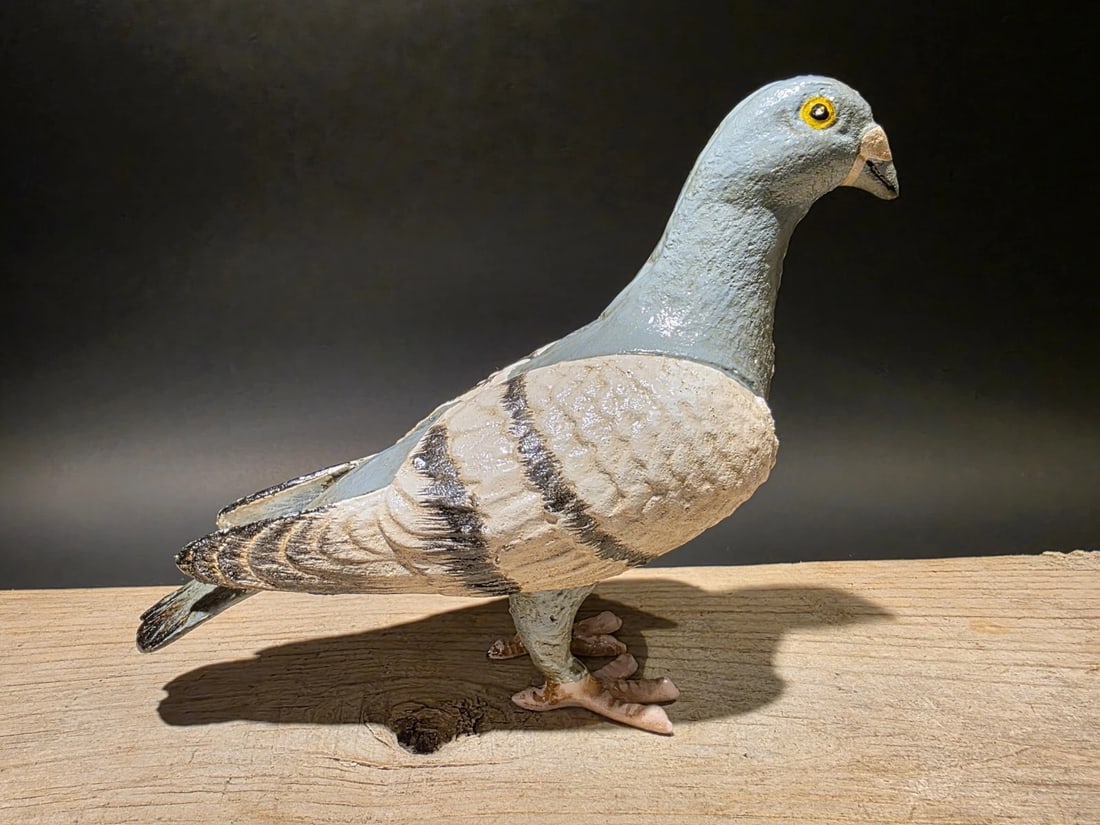 Cast Iron Pigeon Figurine - Vintage Style Dove Bird Statue: 8 1/2" Long x 6" Tall Such neat reproduction antique iron pigeon. Surprisingly heavy. Solid piece. It appears the pieces are cast and hand welded together. Slightly aged patina makes it look and feel