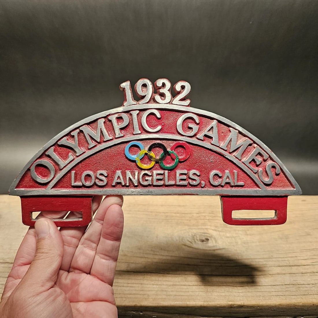 Aluminum 1932 Olympic Games License Plate Fob Topper: 9 3/4" Wide x 5" Tall Wonderful reproduction license plate topper. Good detail aluminum, slightly aged to look like an antique. Certainly hard to tell its age. Reserve: $25.00 Shipping: Domestic: