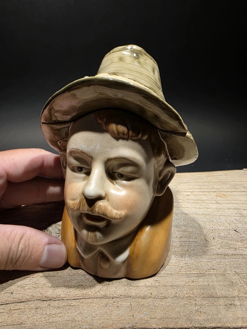 Majolica Ceramic Humidor Figural Tobacco Jar: Reproduction majolica humidor or tobacco jar, likely from Austria, featuring the bust of a man wearing a hat, potentially an "Englishman" caricature. The hat lifts off for storage. Originally used for