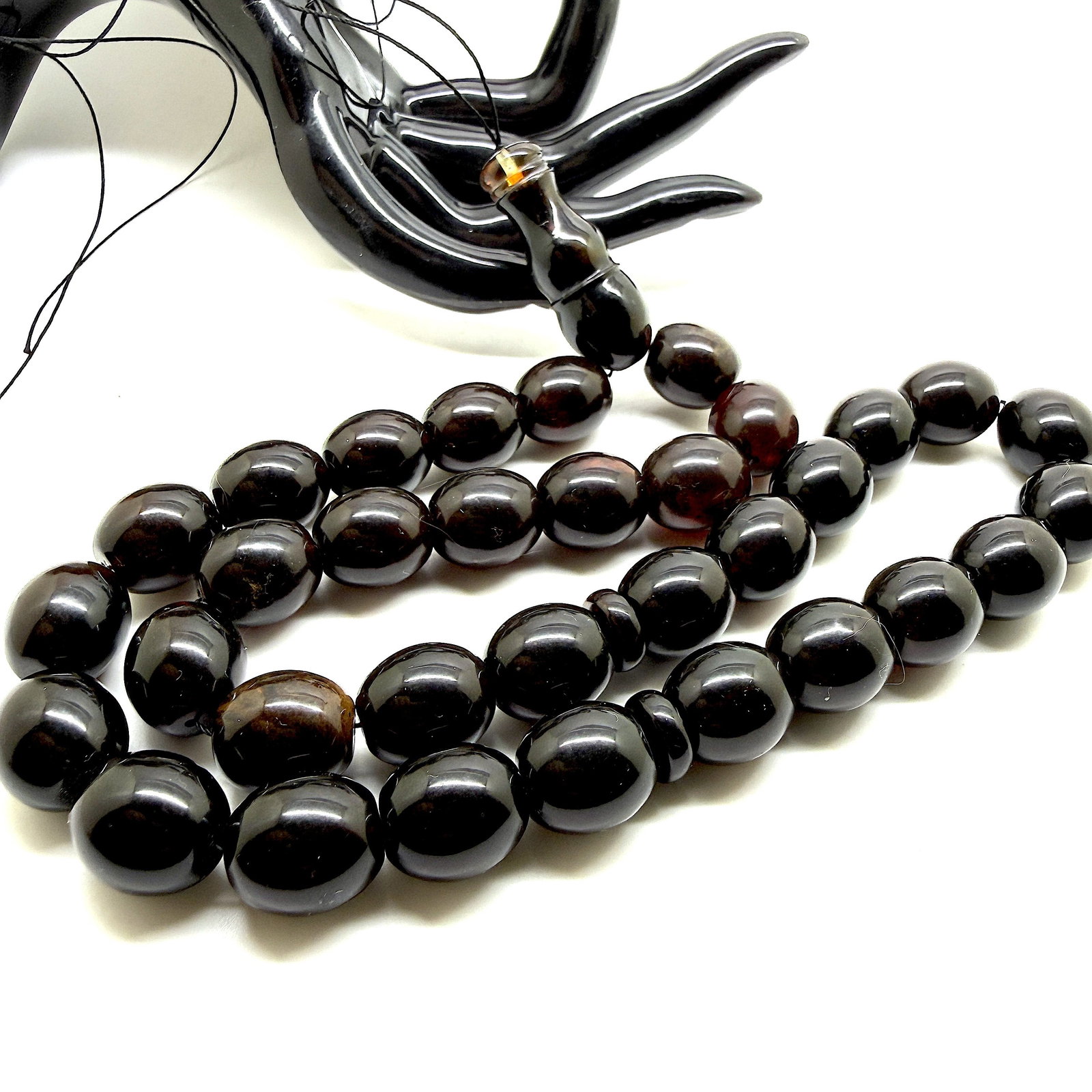 Remarkable Amber Tesbih made from Olive Amber beads: Title:Remarkable Amber Tesbih made from Olive Amber beads Metal:None Gemstone:Reconstituted Amber Weight:54.41 g Size:14x13 mm Made of:(Reconstituted Amber or Whole Stone):Reconstituted Amber