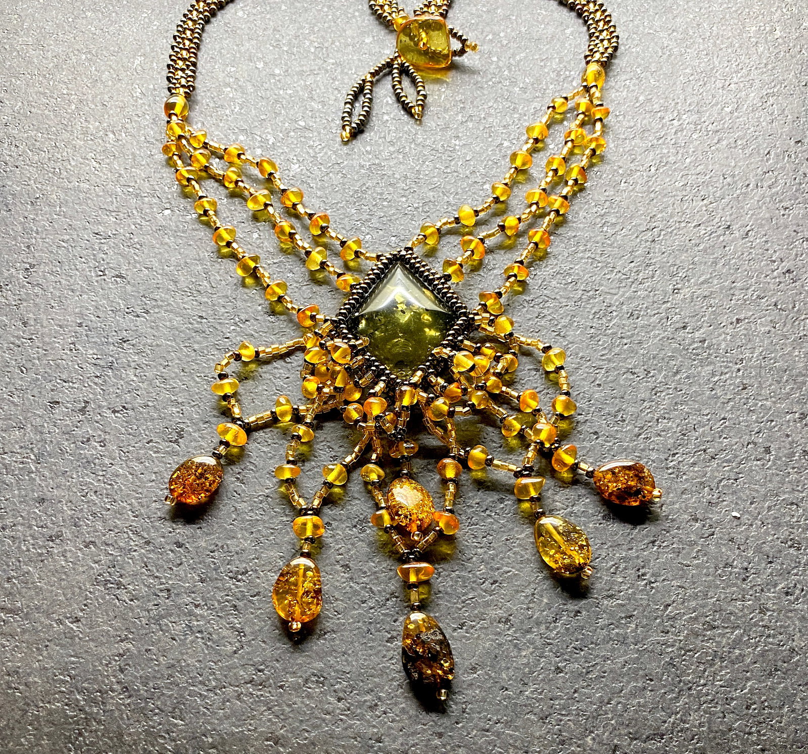 Fascinating Amber Floral Necklace made from leaf like bead ornaments: Title:Fascinating Amber Floral Necklace made from leaf like bead ornaments Metal:None Gemstone:Amber Weight:23.4 g Size:Size: 480.0 x 90.0 x 10.0 mm Size: 18.898 x 3.543 x 0.394 inches Made