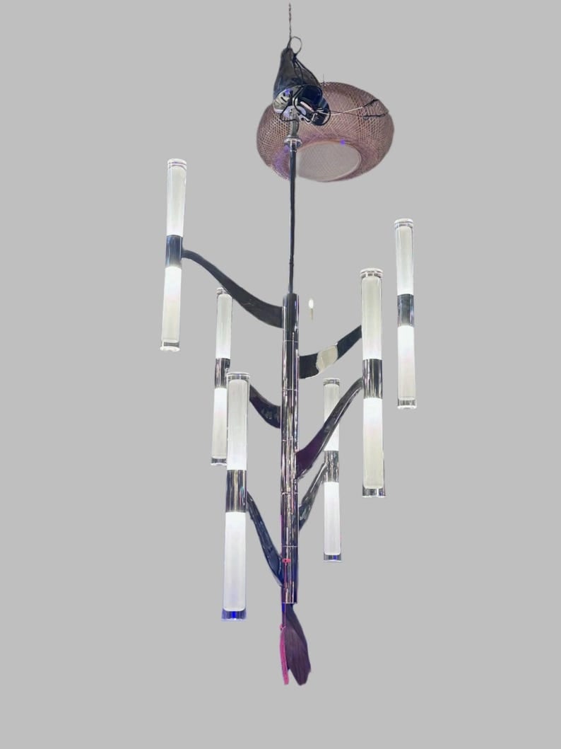 Brenta Chandelier by Aerin: Brenta Medium Tall Chandelier by Aerin This stylish chandelier brings a touch of mid century modern design. A beautiful focal point, it features six cylindrical lights on an elongated frame, which
