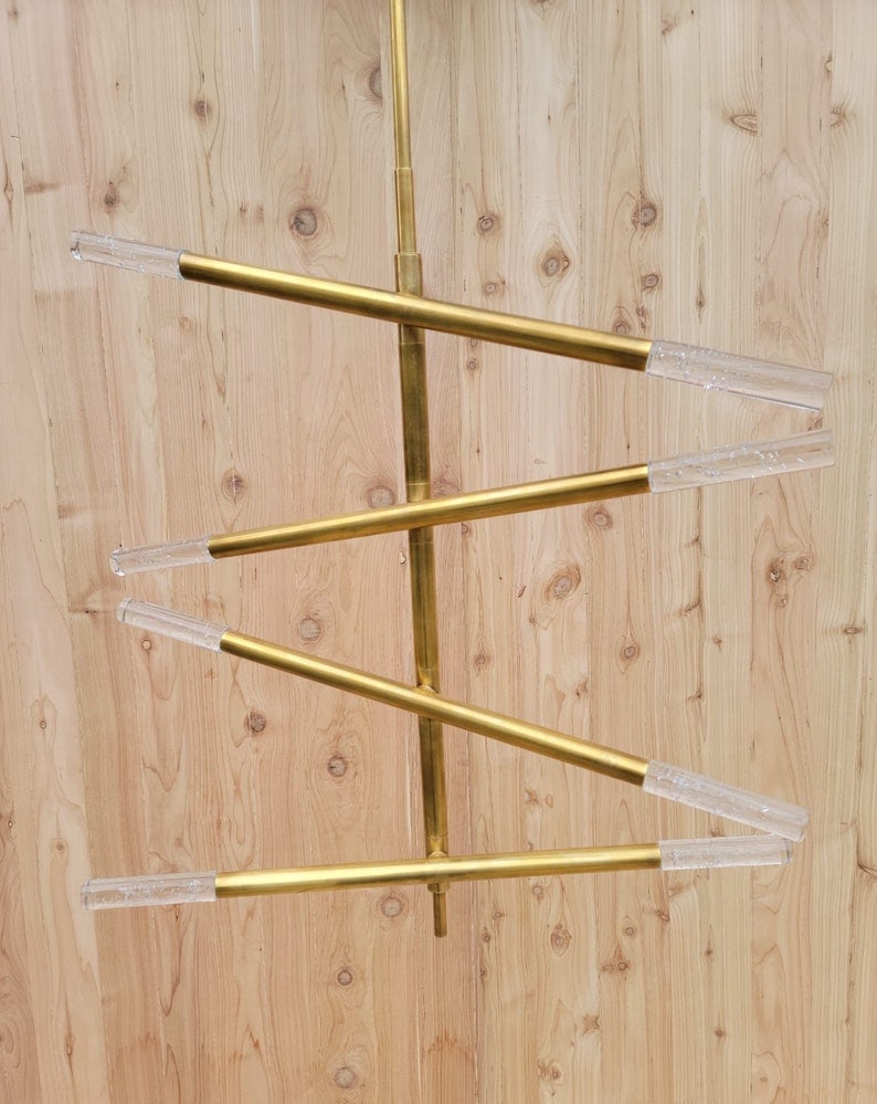 Kelly Wearstler Rousseau Articulating Chandelier in Brass Medium: Kelly Wearstler Rousseau Articulating Chandelier in Antique Burnished Brass with Seeded Glass The stunning Rousseau Chandelier from Visual Comfort adds depth and dimension to any space. The 4 tier