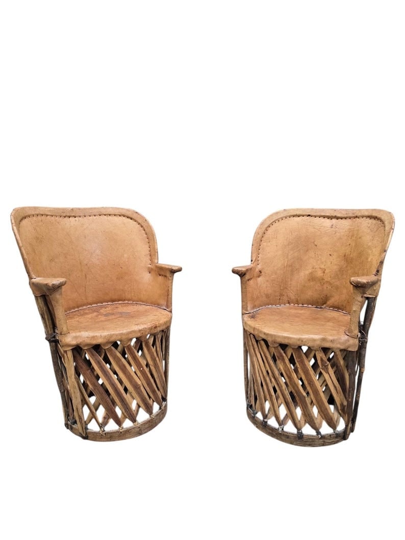 Vintage Native American Leather and Wood Chairs - Pair: Vintage Native American Leather and Wood Chairs - Pair This unique pair of vintage North or Native American leather and wood chairs showcases a unique blend of craftsmanship and cultural heritage.
