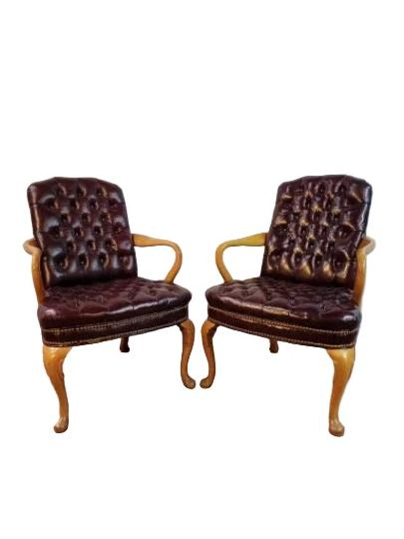 Vintage Traditional Georgian Style Tufted Burgundy Chairs - Pair: Vintage Traditional Georgian Style Designed Tufted Burgundy Naugahyde Armchairs - Pair A classic pair of Georgian design armchairs. The chairs are finished in a honey Birchwood with tufted faux deep